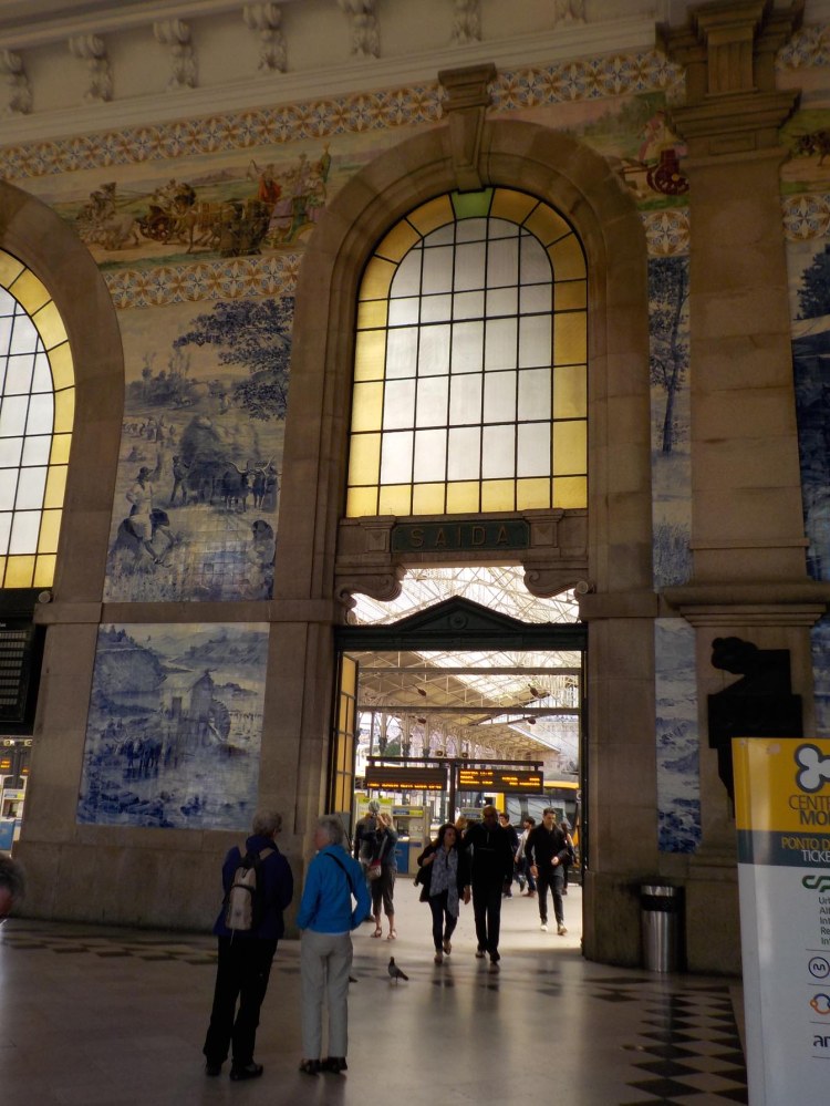 The blue and white tile was installed in the 19th c. when the station was built. The multicolored tile was added during the 20th century.